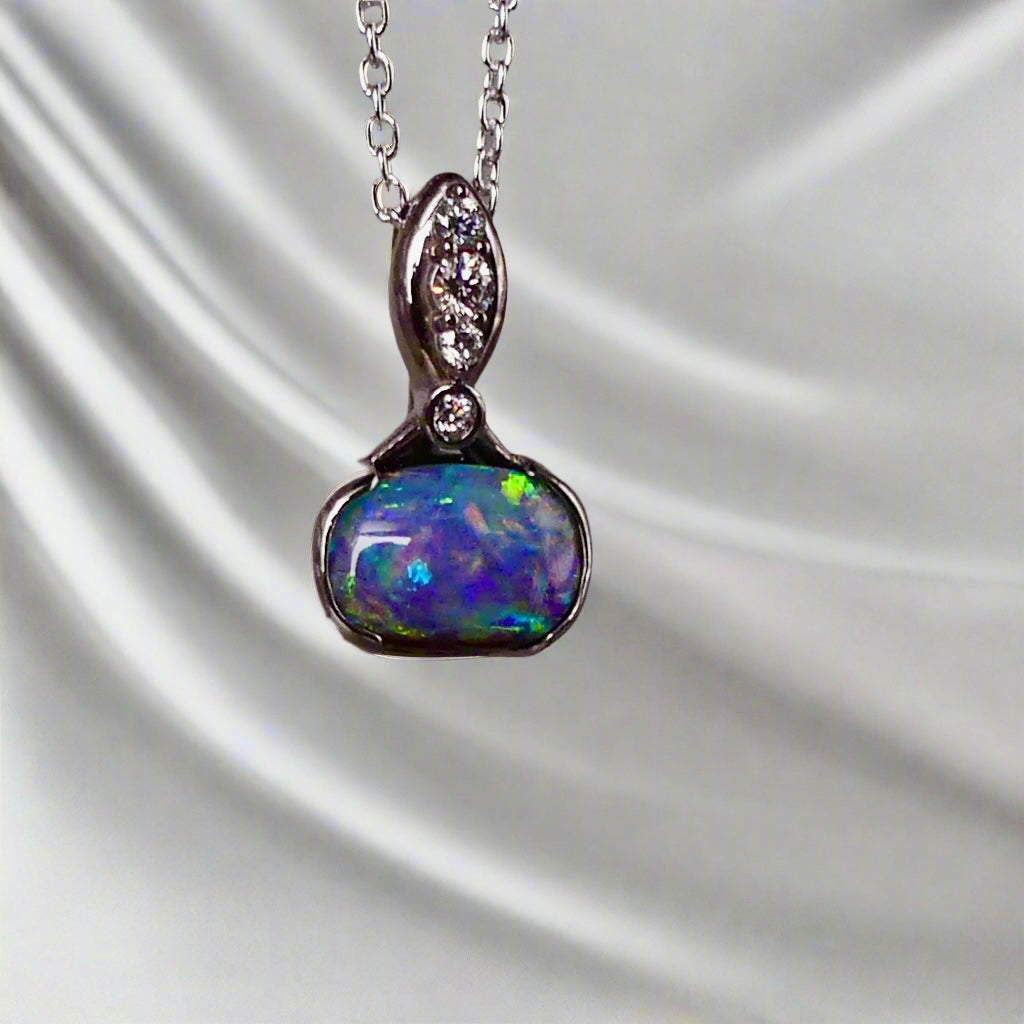 This exquisite pendant features a rare Australian Boulder Opal set in 18k white gold, expertly crafted to highlight the opal’s vibrant play of colors. Accented with natural diamonds, this statement piece that combines exceptional craftsmanship with the distinctive allure of genuine opal.
