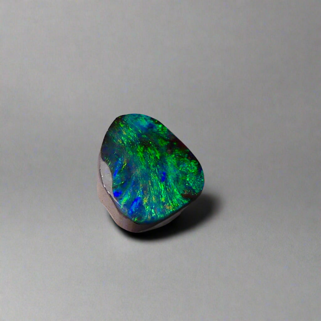 Embrace the stunning beauty of the "Ocean Blue" 2.8ct Australian Boulder Opal, a ring stone that radiates vibrant ocean blues and greens. This exquisite opal captures the essence of the ocean with its brilliant color play, making it an irresistible choice for a unique and elegant jewelry piece