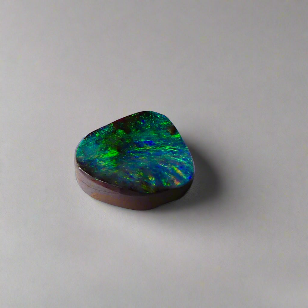 Embrace the stunning beauty of the "Ocean Blue" 2.8ct Australian Boulder Opal, a ring stone that radiates vibrant ocean blues and greens. This exquisite opal captures the essence of the ocean with its brilliant color play, making it an irresistible choice for a unique and elegant jewelry piece.