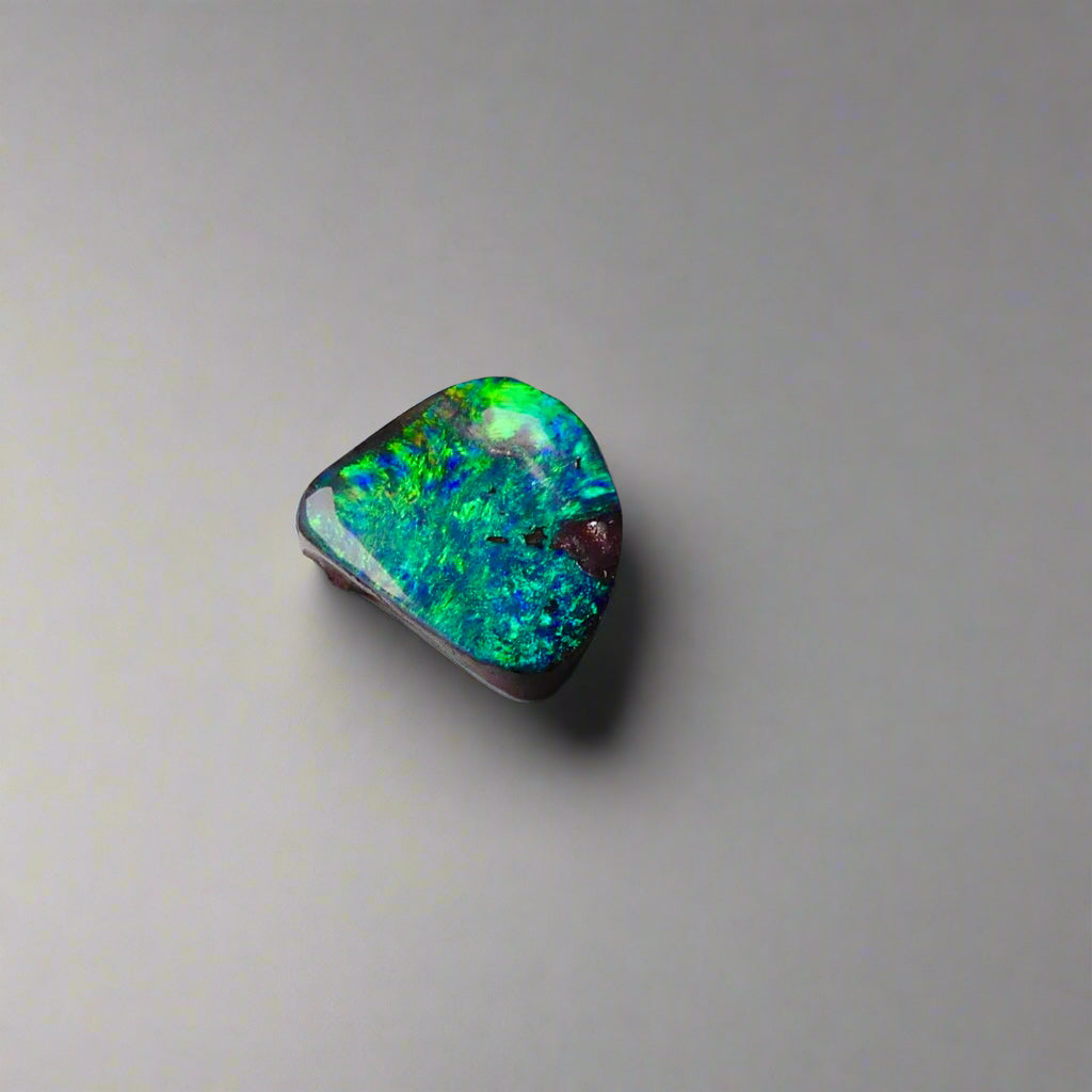Discover the captivating beauty of this 1.8ct Ocean Blue Australian Boulder Opal. Its vibrant blue hues and natural patterns make it a unique opal, Sourced from Australia’s renowned Opalton opal fields, this opal promises both rarity and lasting brilliance.