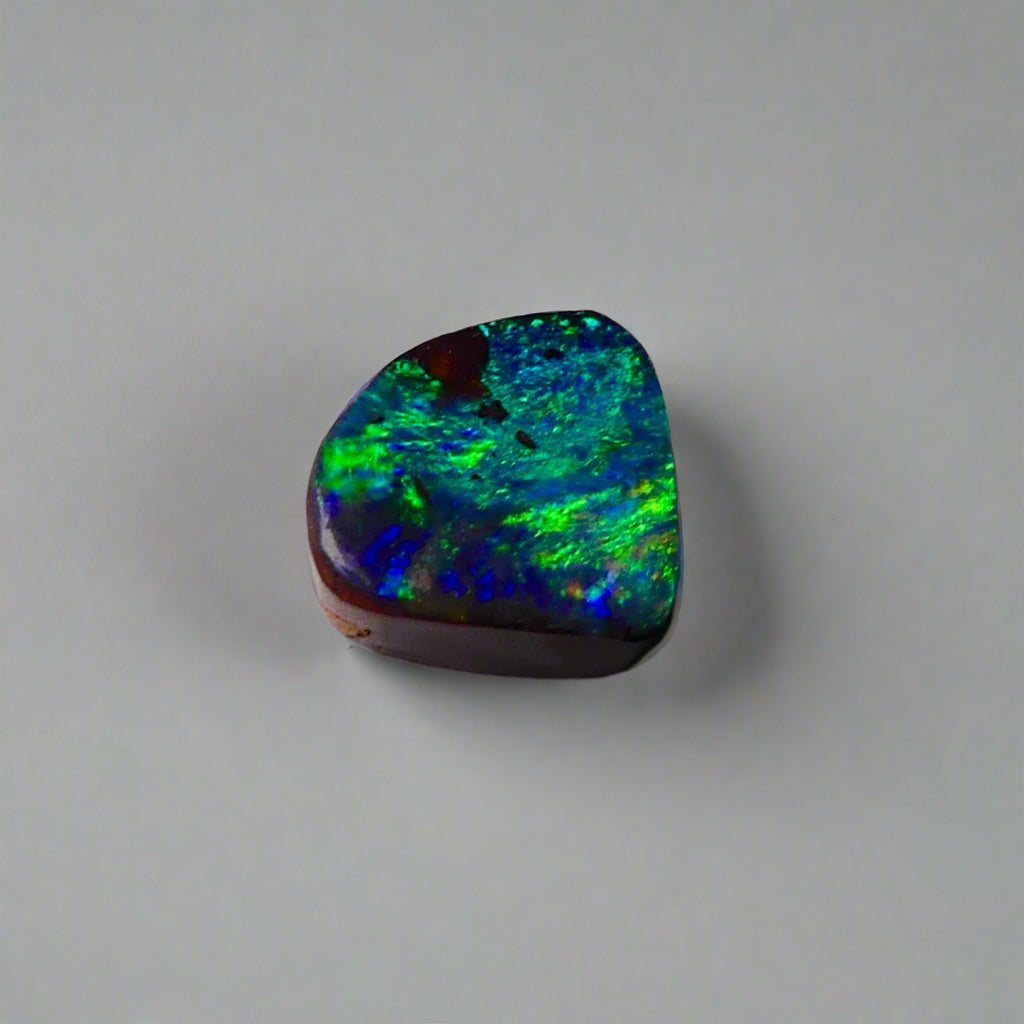 Discover the captivating beauty of this 1.8ct Ocean Blue Australian Boulder Opal. Its vibrant blue hues and natural patterns make it a unique opal, Sourced from Australia’s renowned Opalton opal fields, this opal promises both rarity and lasting brilliance.