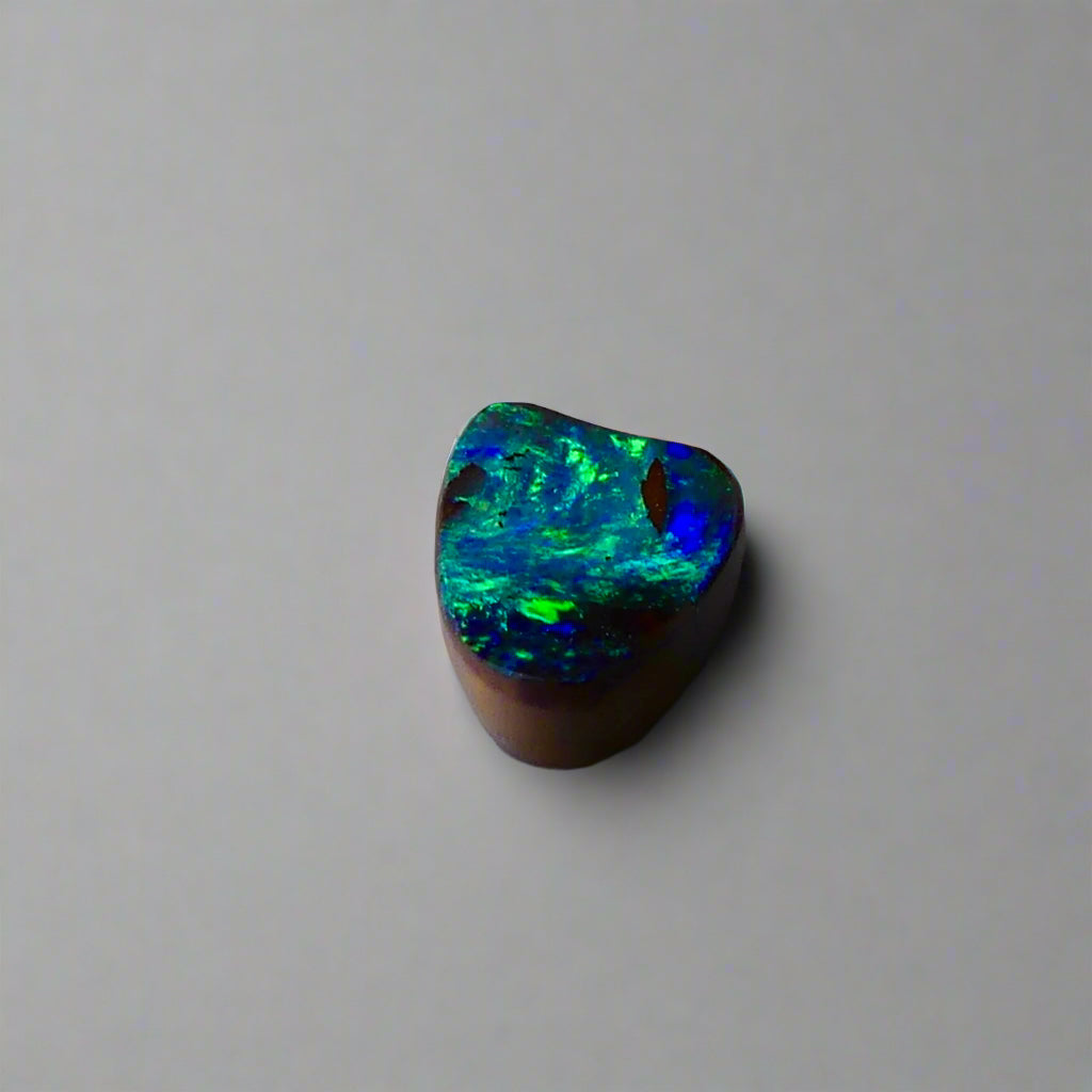 Experience the allure of this stunning 1.90ct Australian Boulder Opal, glowing with vivid green and blue hues. Its vibrant colors and natural brilliance make it an ideal centerpiece for a ring, offering a unique and elegant statement.
