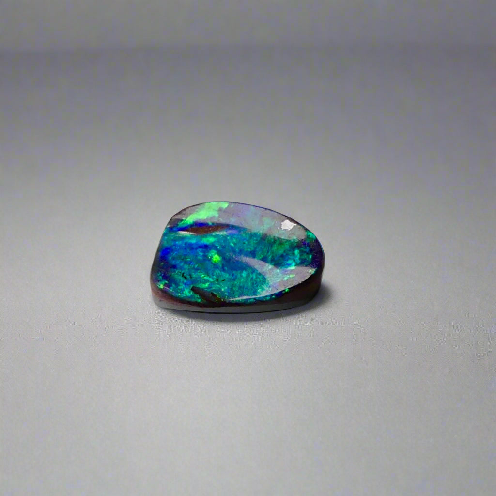 Experience the allure of this stunning 1.90ct Australian Boulder Opal, glowing with vivid green and blue hues. Its vibrant colors and natural brilliance make it an ideal centerpiece for a ring, offering a unique and elegant statement.