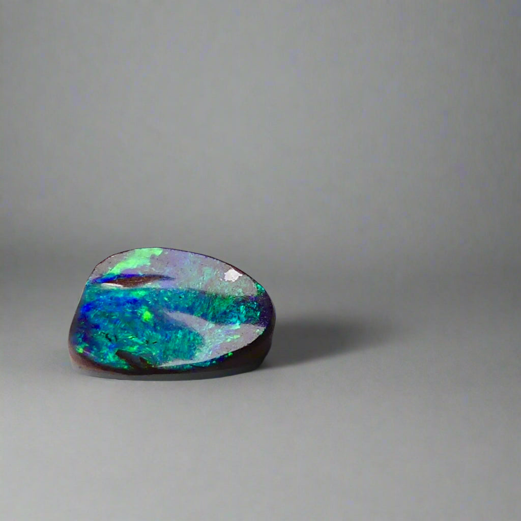 Experience the allure of this stunning 1.90ct Australian Boulder Opal, glowing with vivid green and blue hues. Its vibrant colors and natural brilliance make it an ideal centerpiece for a ring, offering a unique and elegant statement.