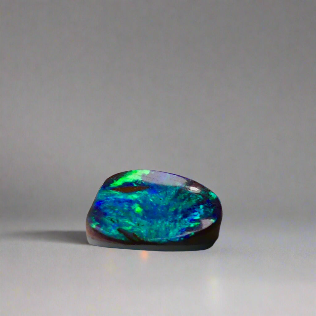 Experience the allure of this stunning 1.90ct Australian Boulder Opal, glowing with vivid green and blue hues. Its vibrant colors and natural brilliance make it an ideal centerpiece for a ring, offering a unique and elegant statement.