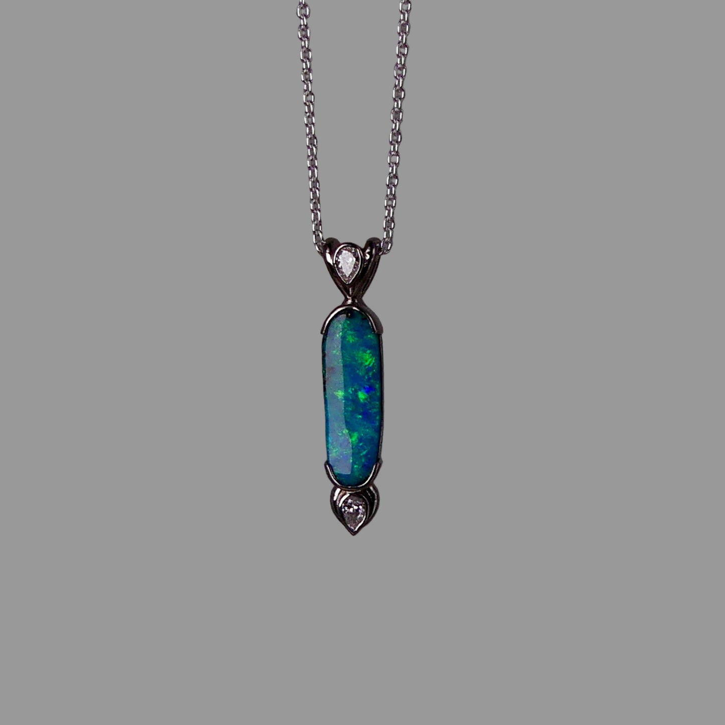 Opal pendant necklace on a dark gray background