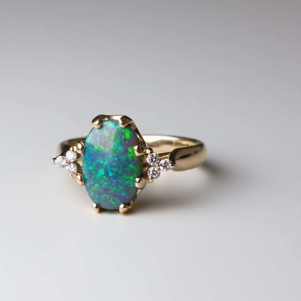 Gold ring with a large opal stone on a gray background