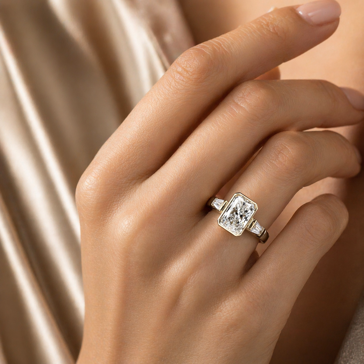 Close-up of a hand wearing a diamond ring with a soft beige background