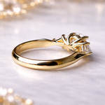 Gold ring with a diamond on a soft, blurred background