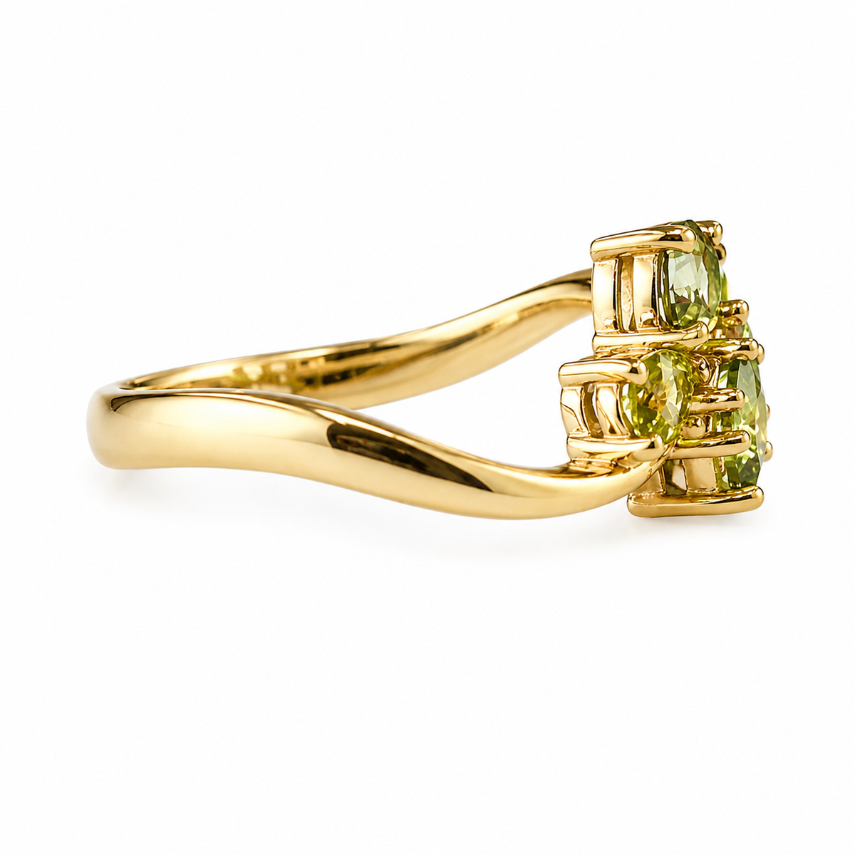 A yellow gold ring featuring a cluster of three light green gemstones in a prong setting, shown on a clean white background.