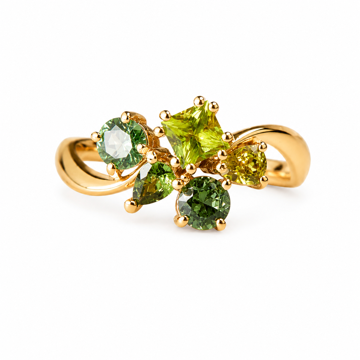 A yellow gold ring featuring a cluster of green gemstones, including a central marquise-cut peridot and surrounding round and pear-cut stones, set against a plain white background.