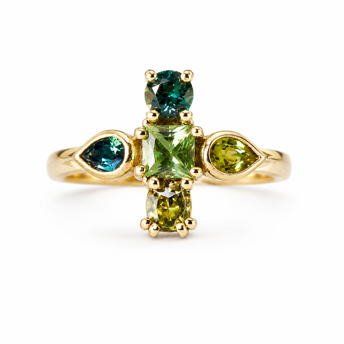 A yellow gold ring featuring a central cluster of green gemstones in marquise, rectangular, and oval shapes, flanked by teardrop-shaped green and blue stones on a white background.