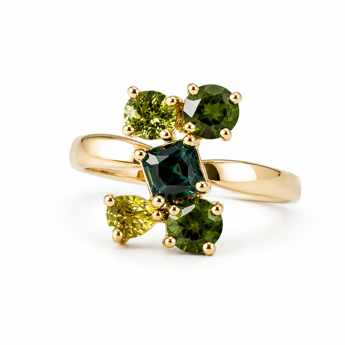 A yellow gold ring featuring a cluster of green gemstones, including a central dark green square-cut stone, two olive green oval stones, and two lime green pear-shaped stones, set against a plain white background.
