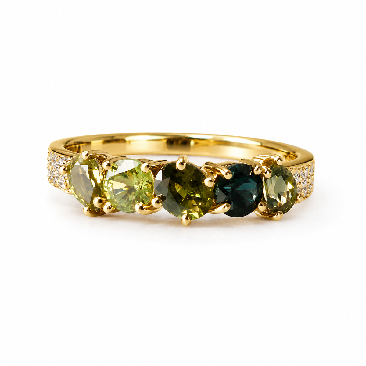 A yellow gold ring featuring three marquise-cut gemstones in olive green, dark teal, and light green, accented by small clear stones on the shoulders, set against a plain white background.