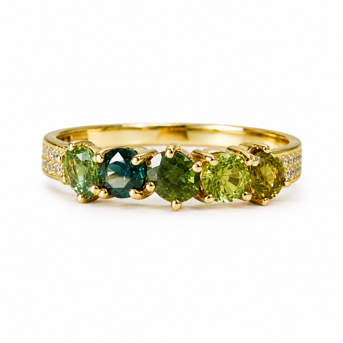 A gold ring featuring three marquise-cut green gemstones in a textured tree-bark style band, shown on a plain white background.