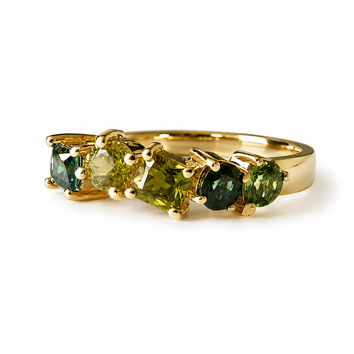 A gold ring featuring five marquise-cut gemstones in shades of green, yellow-green, and dark green, set in a polished yellow gold band on a white background.