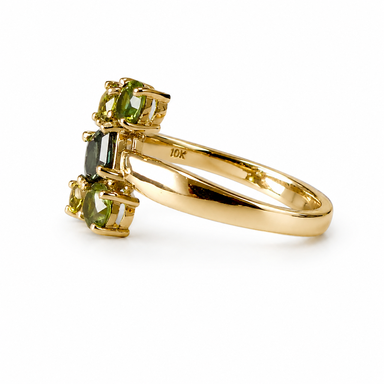 A yellow gold ring featuring three marquise-cut green gemstones in a cluster setting, shown on a clean white background. The inner band is stamped with '10K'.
