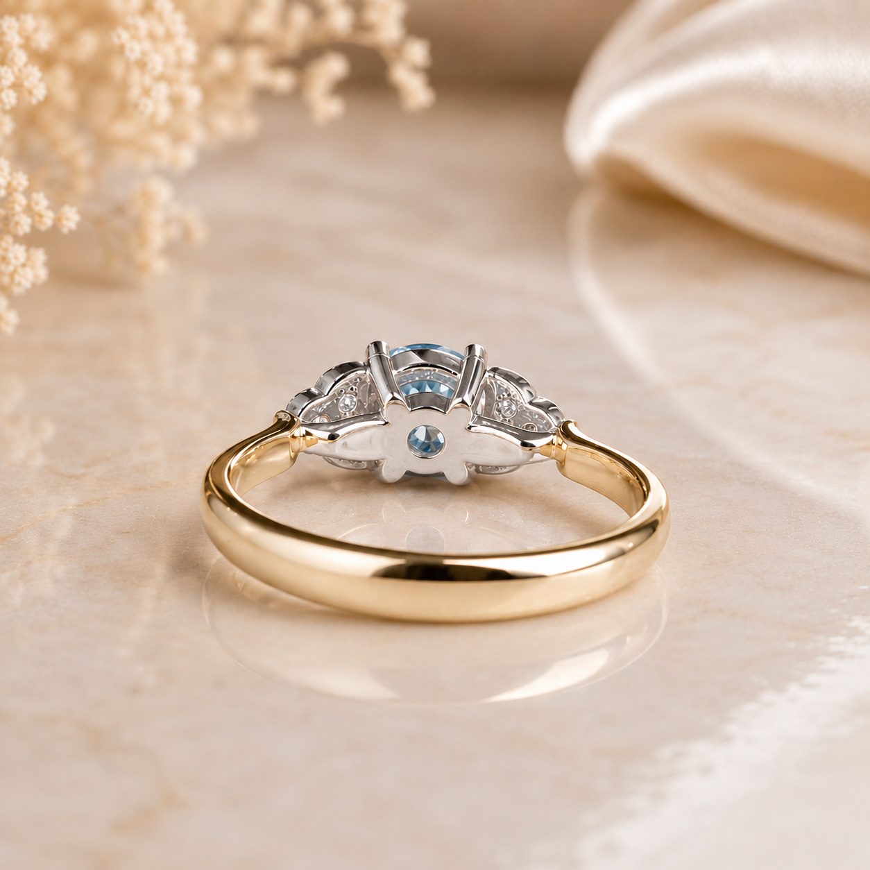 Gold ring with diamonds and a blue gemstone on a beige background