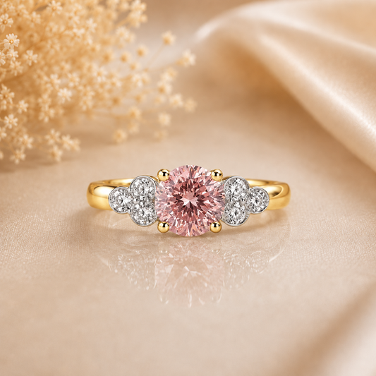 Gold ring with a pink gemstone and smaller diamonds on a beige fabric background