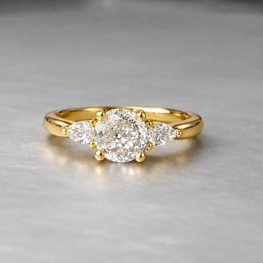 Gold ring with a diamond on a gray background