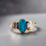 Experience the stunning harmony of nature with our 14k gold Australian Black Opal ring from our Seascapes Collection.

Origin- Lightning Ridge Australia

Opal Weight- 1ct Australian Black Opal

Accent Stone - Mauve Tourmaline

Pearl- Keshi pearl

Setting- 14k gold claw

Ring Size - 6 1/2 us

Handcrafted and designed by Australian Artisians