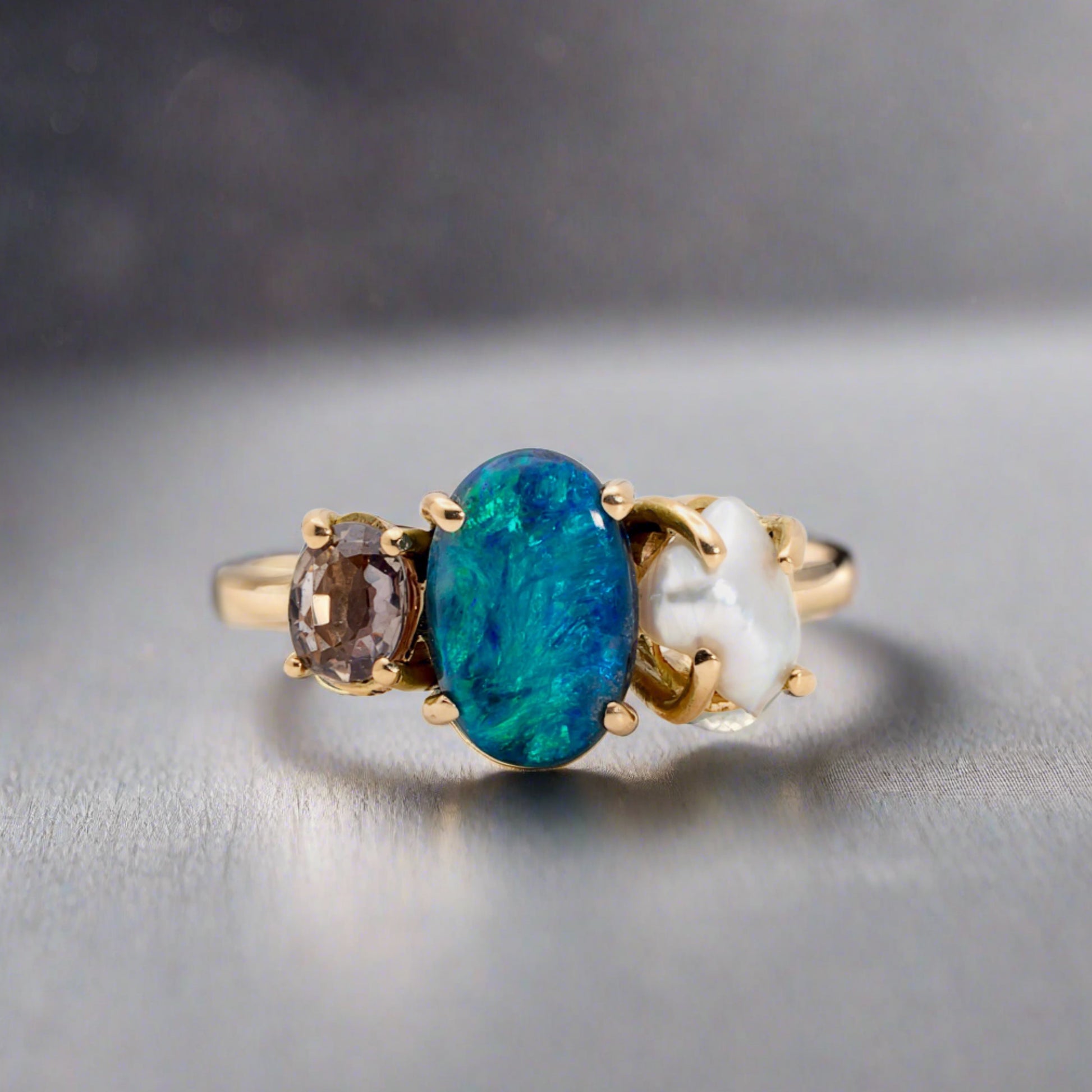 Experience the stunning harmony of nature with our 14k gold Australian Black Opal ring from our Seascapes Collection.

Origin- Lightning Ridge Australia

Opal Weight- 1ct Australian Black Opal

Accent Stone - Mauve Tourmaline

Pearl- Keshi pearl

Setting- 14k gold claw

Ring Size - 6 1/2 us

Handcrafted and designed by Australian Artisians