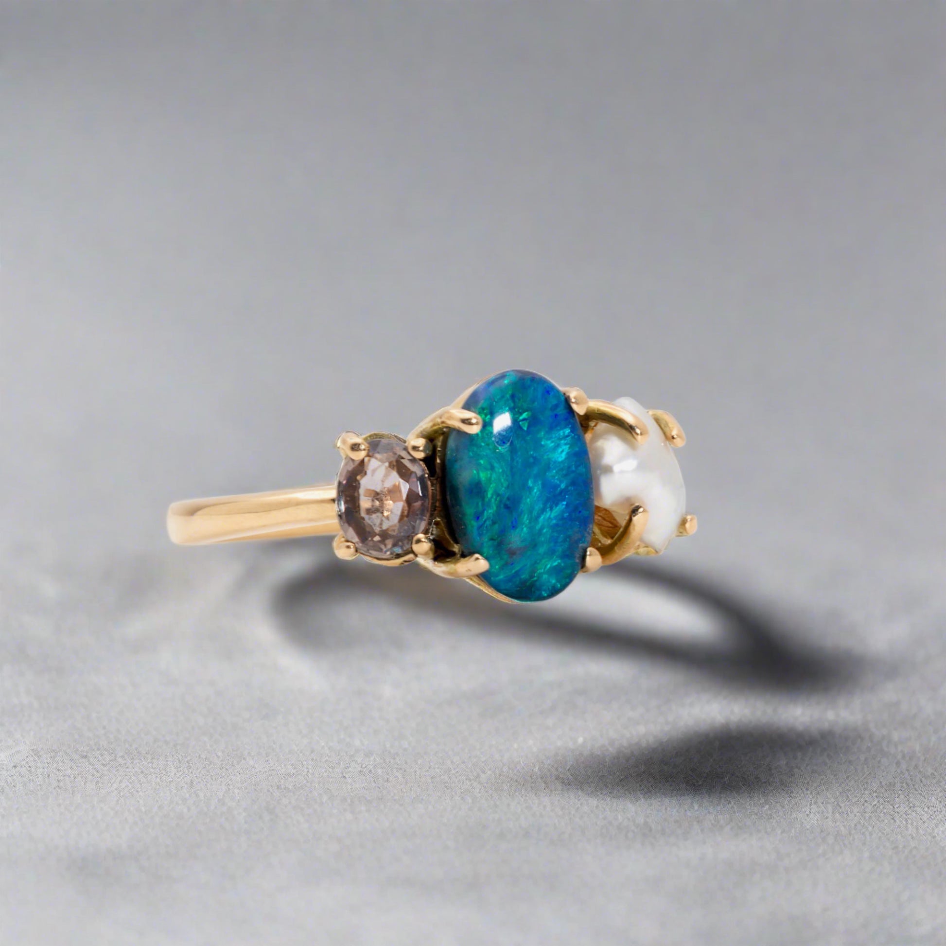 Experience the stunning harmony of nature with our 14k gold Australian Black Opal ring from our Seascapes Collection.

Origin- Lightning Ridge Australia

Opal Weight- 1ct Australian Black Opal

Accent Stone - Mauve Tourmaline

Pearl- Keshi pearl

Setting- 14k gold claw

Ring Size - 6 1/2 us

Handcrafted and designed by Australian Artisians