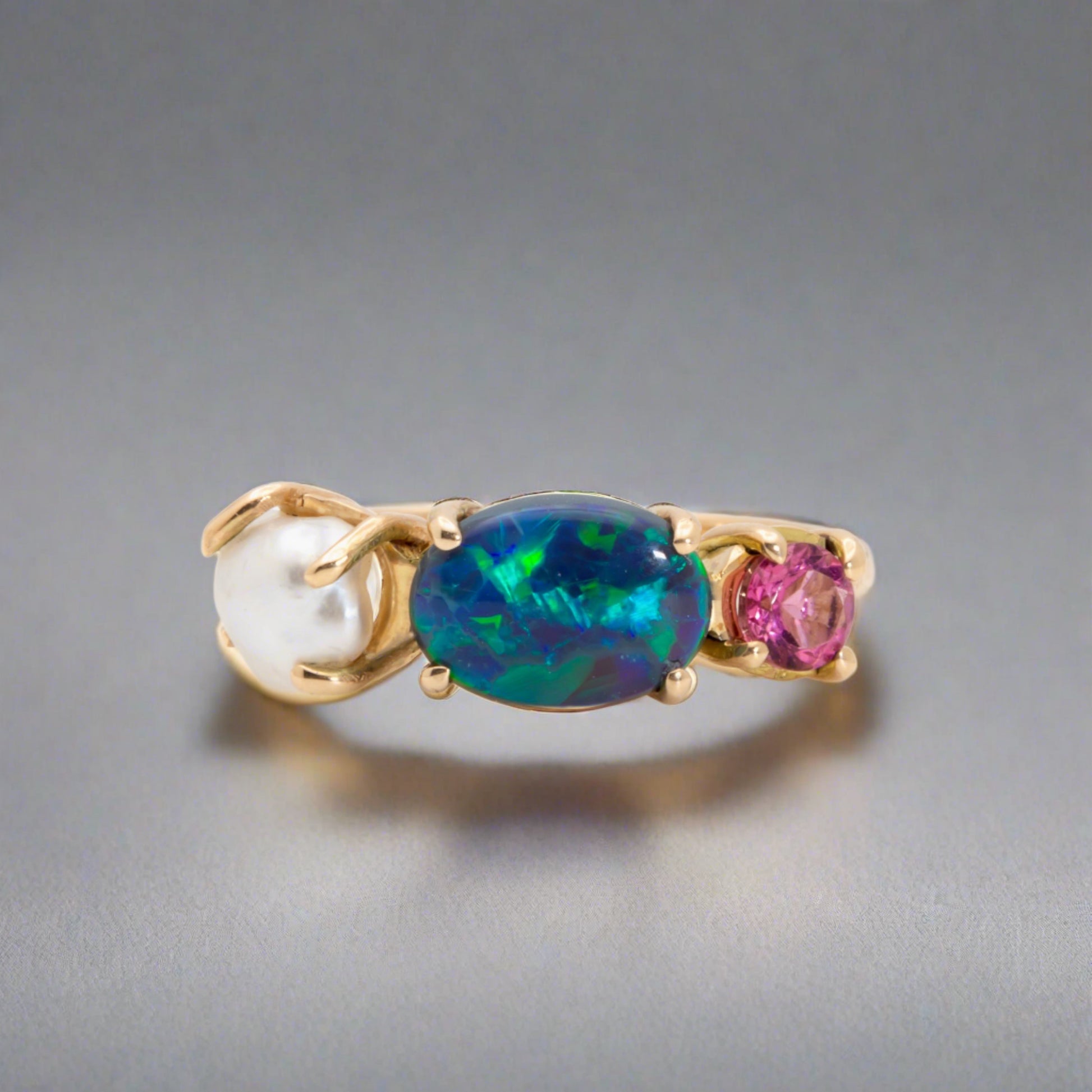 Introducing our stunning Seascapes Collection! This 14k gold ring perfectly captures the beauty and harmony of nature's wonders. Handcrafted to perfection, it is the epitome of elegance.

Origin- Lightning Ridge Australia

Opal Weight- 1ct Australian Black Opal.

Setting- 14k Gold Claw Setting

Accent Stone- Pink Tourmaline

Pearl- Keshi Pearl

Size - 7us -

Handcrafted and designed by Australian Artisans