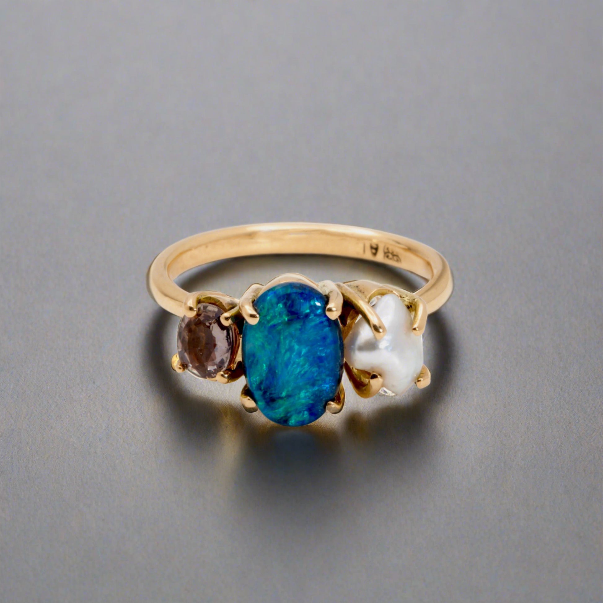 Experience the stunning harmony of nature with our 14k gold Australian Black Opal ring from our Seascapes Collection.

Origin- Lightning Ridge Australia

Opal Weight- 1ct Australian Black Opal

Accent Stone - Mauve Tourmaline

Pearl- Keshi pearl

Setting- 14k gold claw

Ring Size - 6 1/2 us

Handcrafted and designed by Australian Artisians