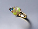 Introducing our stunning 14k Gold Australian Crystal Opal Ring. Ethically sourced from Lightning Ridge Australia, its mesmerizing play-of-color is unlike any other. Each piece is truly one-of-a-kind

Origin- Lightning Ridge Australia

Opal Weight- 1ct Australian Crystal Opal

Setting- 14k Claw Setting

Accent Stone- Swiss Blue Topaz

Ring Size- 6 1/2us.

Handcrafted with precision and passion by Australian Artisans.