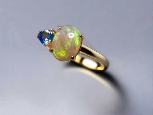 Introducing our stunning 14k Gold Australian Crystal Opal Ring. Ethically sourced from Lightning Ridge Australia, its mesmerizing play-of-color is unlike any other. Each piece is truly one-of-a-kind

Origin- Lightning Ridge Australia

Opal Weight- 1ct Australian Crystal Opal

Setting- 14k Claw Setting

Accent Stone- Swiss Blue Topaz

Ring Size- 6 1/2us.

Handcrafted with precision and passion by Australian Artisans.