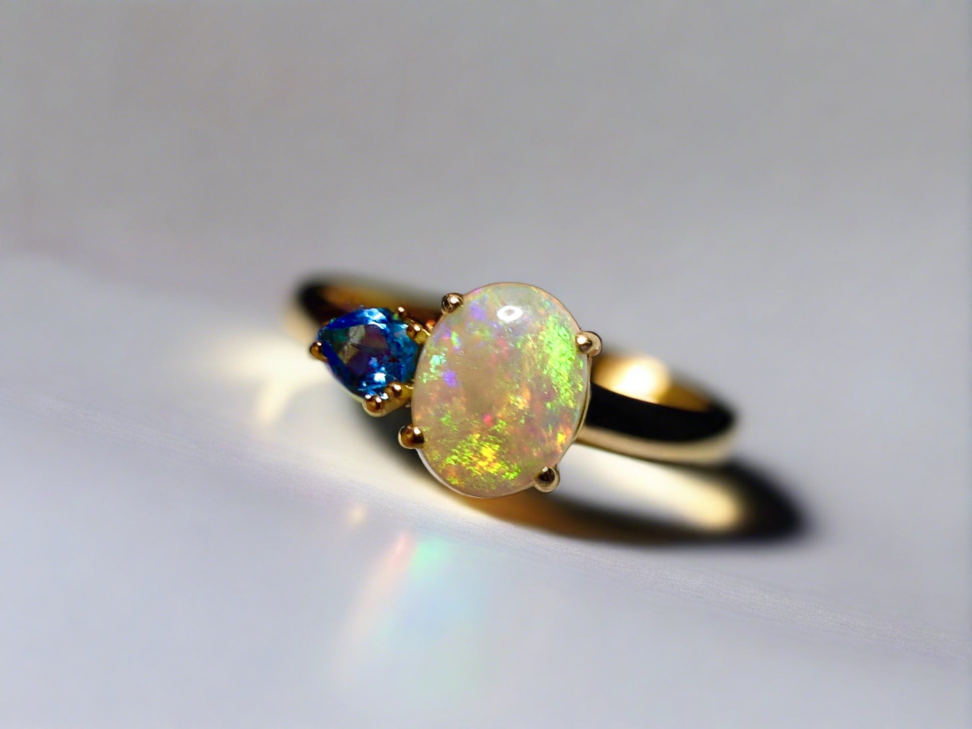 Introducing our stunning 14k Gold Australian Crystal Opal Ring. Ethically sourced from Lightning Ridge Australia, its mesmerizing play-of-color is unlike any other. Each piece is truly one-of-a-kind

Origin- Lightning Ridge Australia

Opal Weight- 1ct Australian Crystal Opal

Setting- 14k Claw Setting

Accent Stone- Swiss Blue Topaz

Ring Size- 6 1/2us.

Handcrafted with precision and passion by Australian Artisans.