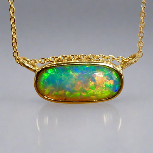 Experience the brilliance of our 18k Gold Australian Crystal Opal Pendant. Ethically mined from Coober Pedy, Australia, this opal is a stunning representation of the outback's natural beauty

Origin- Coober Pedy Australia

Opal Weight- 3ct Australian Crystal Opal

Setting- 18k Gold Bezel Set

Chain- 18k Gold Cable, 45cm in Length

Handcrafted and designed by Australian Artisans