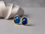 Introducing our exquisite Australian Black Opal Stud Earrings, a captivating fusion of natural beauty and fine craftsmanship. Each earring features a mesmerizing Australian black opal, renowned for its rich play of colors and inherent elegance.

Origin- Lighting Ridge Australia

Opal Weight- Combined weight 2ct Australian Black Opal

Setting- 14k Gold Bezel set Stud Earrings&nbsp;

Size- 10 x 8mm

Designed by Australian Artisans with Elegance and sophistication in mind.