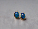 Introducing our exquisite Australian Black Opal Stud Earrings, a captivating fusion of natural beauty and fine craftsmanship. Each earring features a mesmerizing Australian black opal, renowned for its rich play of colors and inherent elegance.

Origin- Lighting Ridge Australia

Opal Weight- Combined weight 2ct Australian Black Opal

Setting- 14k Gold Bezel set Stud Earrings&nbsp;

Size- 10 x 8mm

Designed by Australian Artisans with Elegance and sophistication in mind.