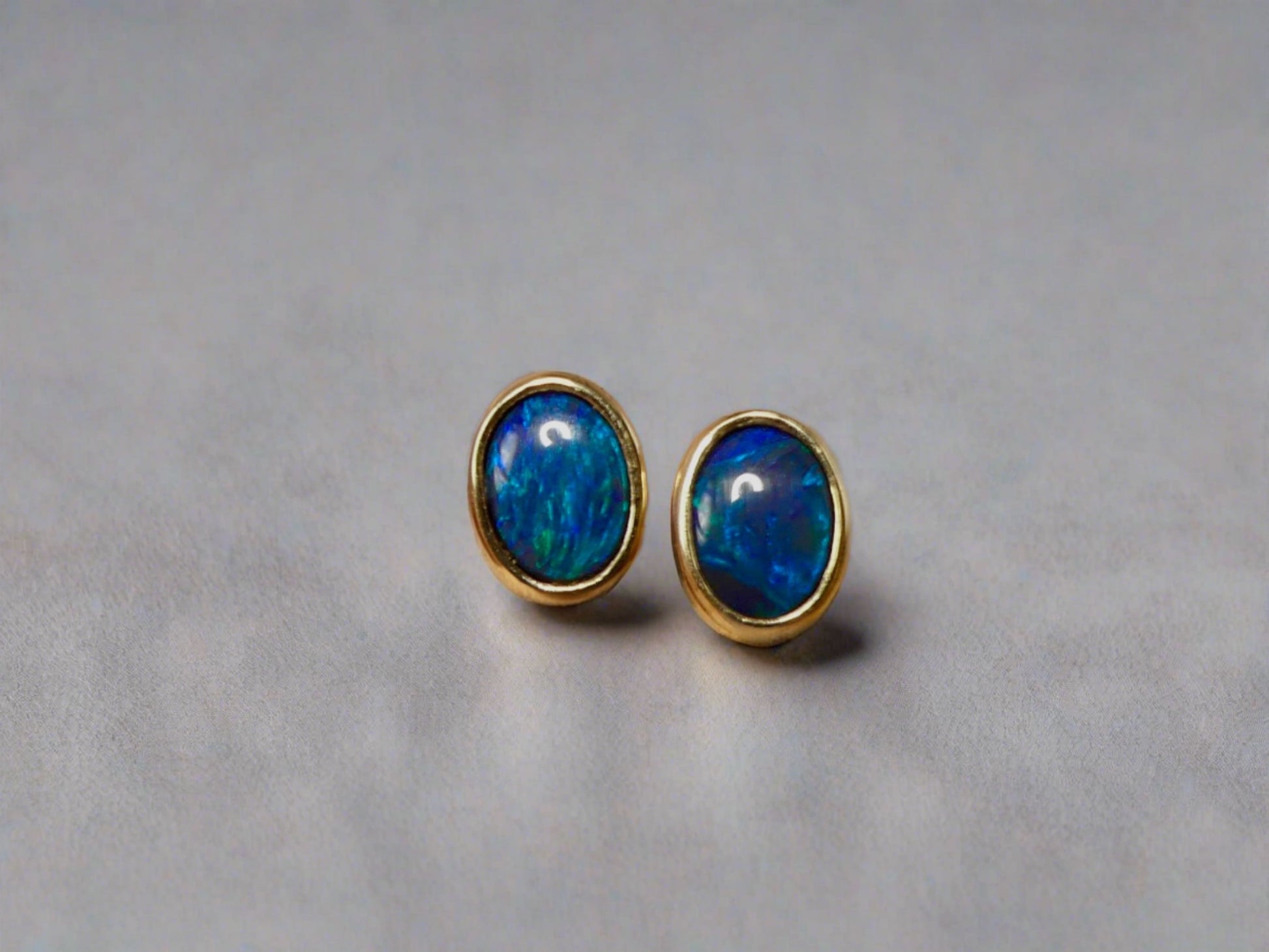 Introducing our exquisite Australian Black Opal Stud Earrings, a captivating fusion of natural beauty and fine craftsmanship. Each earring features a mesmerizing Australian black opal, renowned for its rich play of colors and inherent elegance.

Origin- Lighting Ridge Australia

Opal Weight- Combined weight 2ct Australian Black Opal

Setting- 14k Gold Bezel set Stud Earrings&nbsp;

Size- 10 x 8mm

Designed by Australian Artisans with Elegance and sophistication in mind.