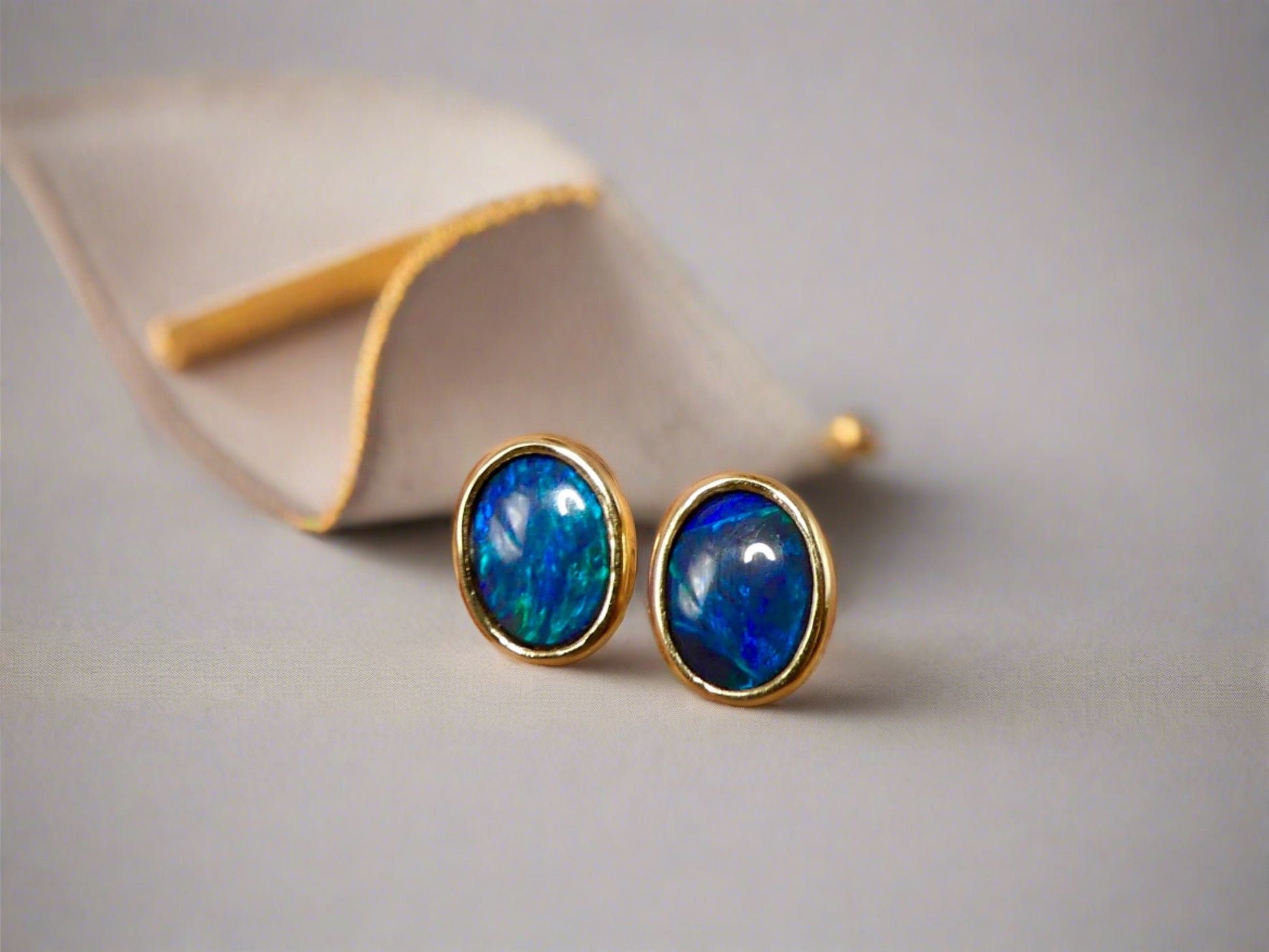 Introducing our exquisite Australian Black Opal Stud Earrings, a captivating fusion of natural beauty and fine craftsmanship. Each earring features a mesmerizing Australian black opal, renowned for its rich play of colors and inherent elegance.

Origin- Lighting Ridge Australia

Opal Weight- Combined weight 2ct Australian Black Opal

Setting- 14k Gold Bezel set Stud Earrings&nbsp;

Size- 10 x 8mm

Designed by Australian Artisans with Elegance and sophistication in mind.