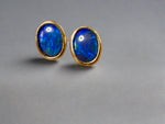 Introducing our exquisite Australian Black Opal Stud Earrings, a captivating fusion of natural beauty and fine craftsmanship. Each earring features a mesmerizing Australian black opal, renowned for its rich play of colors and inherent elegance.

Origin- Lighting Ridge Australia

Opal Weight- Combined weight 2ct Australian Black Opal

Setting- 14k Gold Bezel set Stud Earrings&nbsp;

Size- 10 x 8mm

Designed by Australian Artisans with Elegance and sophistication in mind.