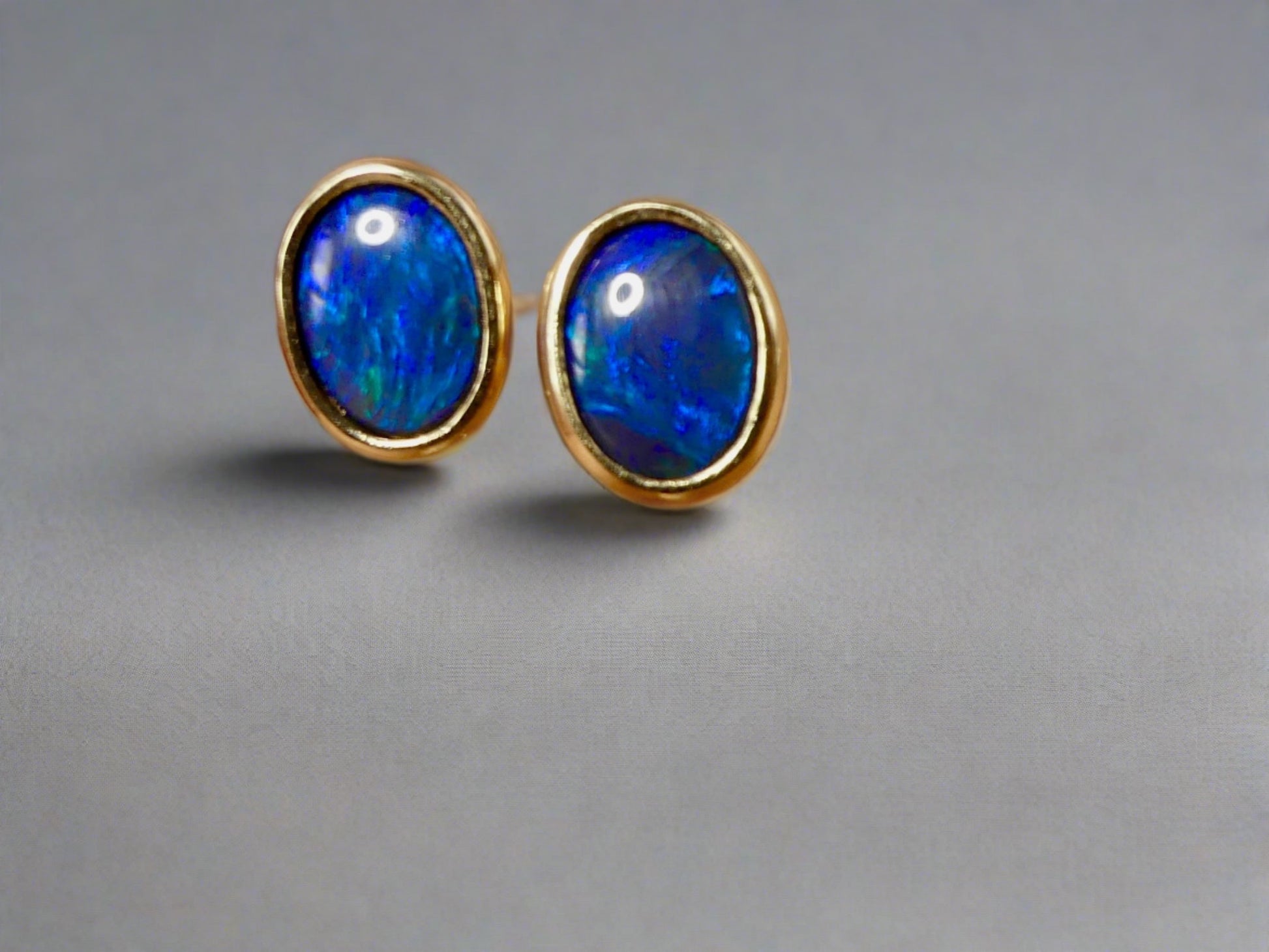 Introducing our exquisite Australian Black Opal Stud Earrings, a captivating fusion of natural beauty and fine craftsmanship. Each earring features a mesmerizing Australian black opal, renowned for its rich play of colors and inherent elegance.

Origin- Lighting Ridge Australia

Opal Weight- Combined weight 2ct Australian Black Opal

Setting- 14k Gold Bezel set Stud Earrings&nbsp;

Size- 10 x 8mm

Designed by Australian Artisans with Elegance and sophistication in mind.