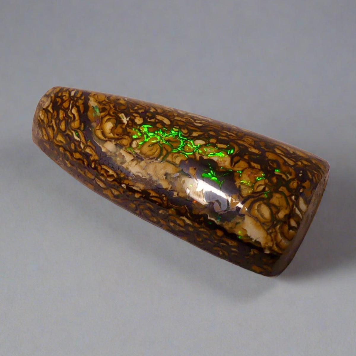 Experience the stunning 27.6ct Koroit Boulder Opal. Its vibrant greens and directional flash make it a unique and breathtaking addition to any collection.

Origin- Queensland Australia

Opal Weight- 27.4ct Koroit Boulder Opal

Size- 29 x 15mm

Beautiful Opal suitable for a Pendant setting.