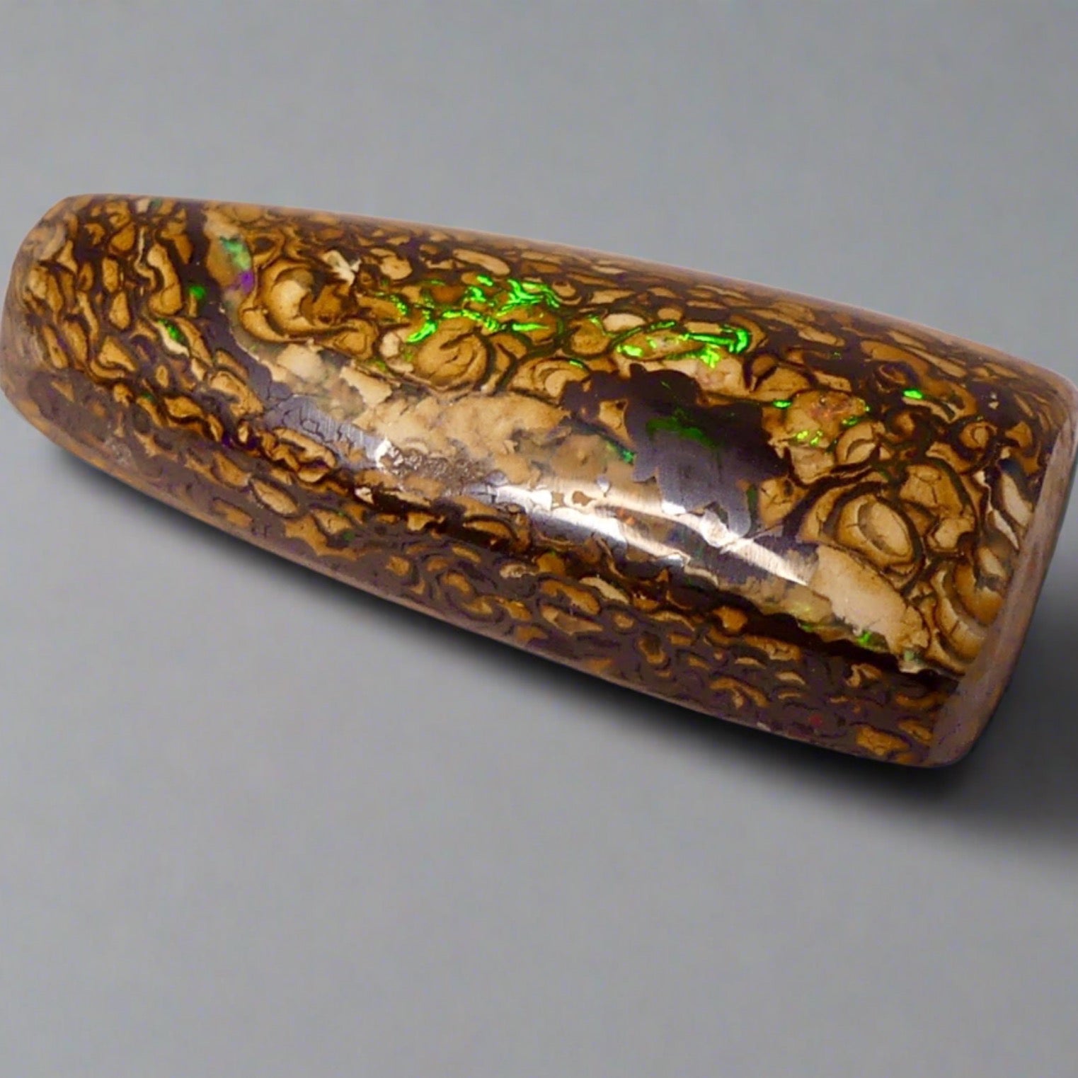 Experience the stunning 27.6ct Koroit Boulder Opal. Its vibrant greens and directional flash make it a unique and breathtaking addition to any collection.

Origin- Queensland Australia

Opal Weight- 27.4ct Koroit Boulder Opal

Size- 29 x 15mm

Beautiful Opal suitable for a Pendant setting.