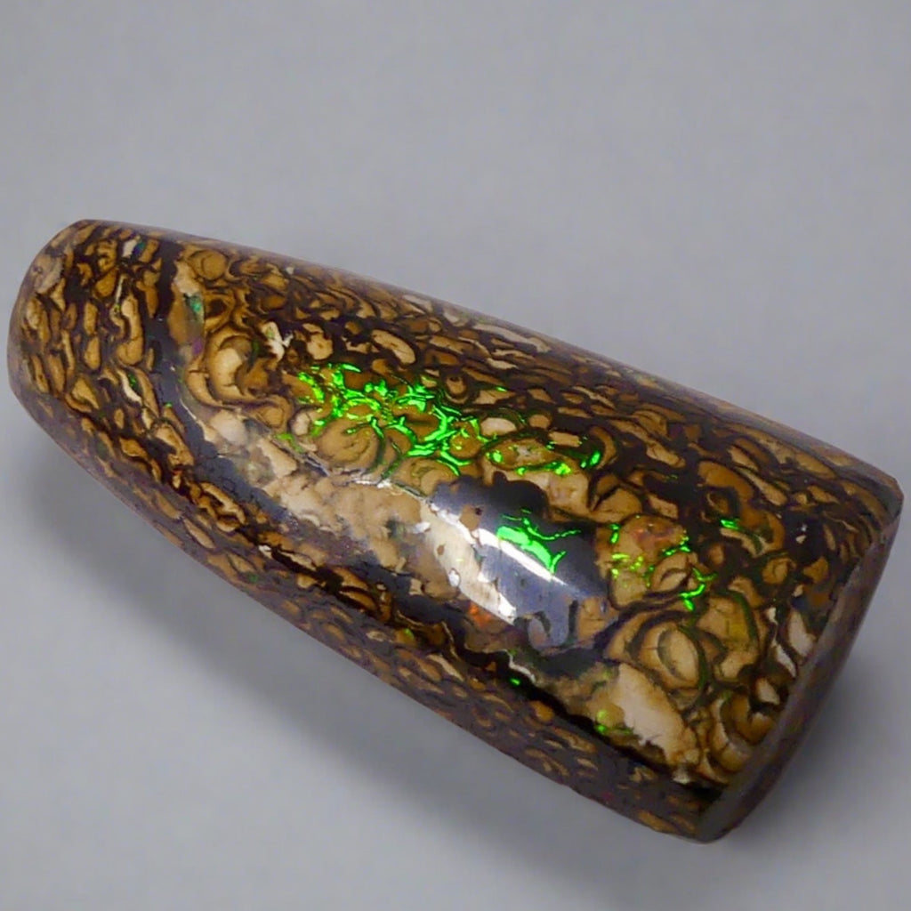 Experience the stunning 27.6ct Koroit Boulder Opal. Its vibrant greens and directional flash make it a unique and breathtaking addition to any collection.

Origin- Queensland Australia

Opal Weight- 27.4ct Koroit Boulder Opal

Size- 29 x 15mm

Beautiful Opal suitable for a Pendant setting.