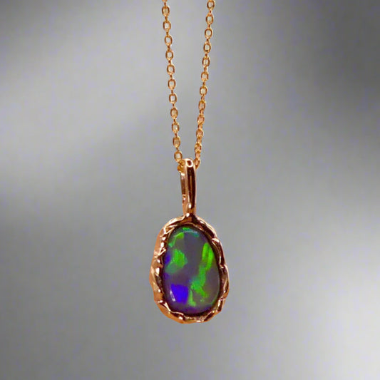 Uncover the stunning Australian opal beauty of our 9k Gold Lightning Ridge Opal pendant. Featuring a unique lava-inspired handcrafted design with green, blue, and gold tones, this high-quality masterpiece is a lasting addition to your collection.

Origin- Ethically Mined in Lightning Ridge Australia

Opal Weight- 1.5ct Lightning Ridge Crystal Opal

Setting- 9k Gold Lava inspired custom design

Chain- 9k Gold Cable Chain 45cm in Length

Treatments- None- 100% Solid Australian Opal
