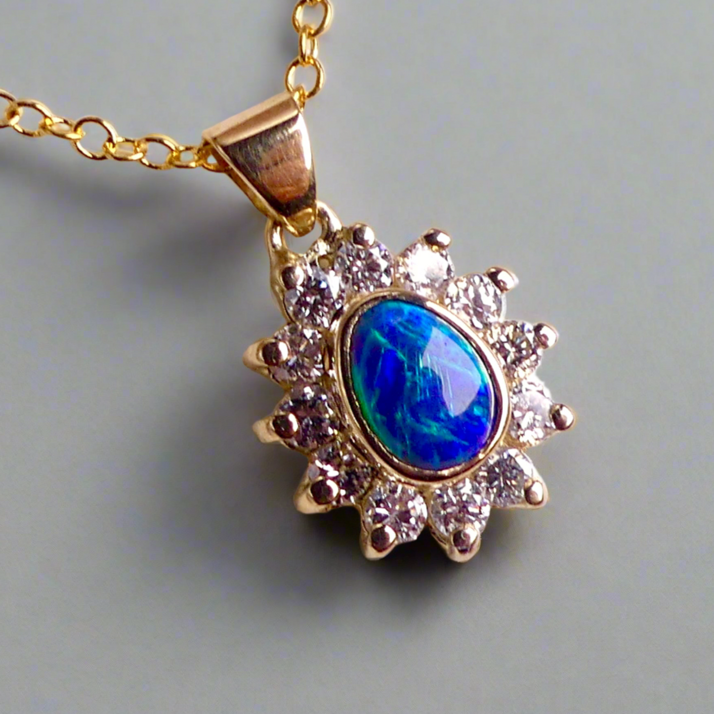 Experience the captivating allure of this handcrafted 18K Yellow Gold Opal &amp; Diamond Halo Pendant. With a striking Lightning Ridge opal showcasing a rare and sought-after script pattern consisting of blue, green, and gold tones, complemented by radiant diamonds, this necklace is a sophisticated and essential piece for any collection.

Origin- Lightning Ridge Australia

Opal Weight- 1ct Australian Lightning Ridge Semi Black Opal

Setting- 18k Yellow Gold Bezel set, claw set Diamond Halo