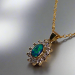 Experience the captivating allure of this handcrafted 18K Yellow Gold Opal &amp; Diamond Halo Pendant. With a striking Lightning Ridge opal showcasing a rare and sought-after script pattern consisting of blue, green, and gold tones, complemented by radiant diamonds, this necklace is a sophisticated and essential piece for any collection.

Origin- Lightning Ridge Australia

Opal Weight- 1ct Australian Lightning Ridge Semi Black Opal

Setting- 18k Yellow Gold Bezel set, claw set Diamond Halo