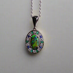 Lightning Ridge Australian black opal with strong, highly prized colors of reds, orange, and yellows is undoubtedly a remarkable gemstone. Expertly crafted from 18k white gold, this pendant showcases the mesmerizing beauty of an Australian black opal, surrounded by sparkling diamonds, emeralds, and sapphires. Exquisite in design and quality, this pendant is a luxurious addition to any jewelry collection. Elevate your style with this stunning piece.

Opal Weight- 1.1ct

Body Tone- N1 Australian Black