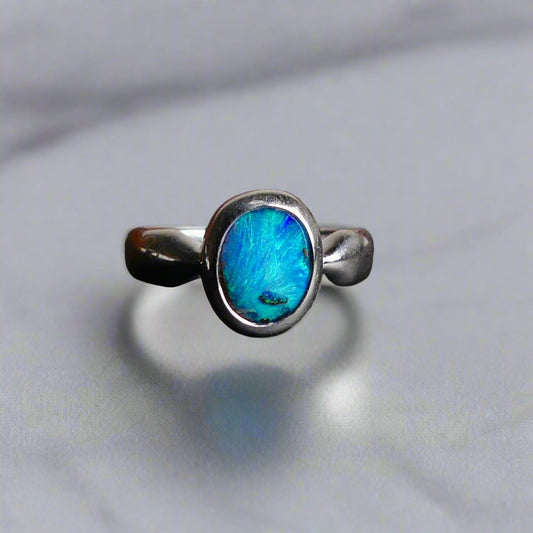 This Vibrant Sterling Silver Boulder Opal Ring showcases stunning ocean blue hues, making it a truly eye-catching accessory. Crafted with high-quality sterling silver and featuring a boulder opal, this ring is both beautiful and durable. Elevate any outfit with this striking piece of jewelry.

Origin- Ethically mined in Queensland Australia

Opal Weight- 1.9ct

Setting- Sterling Silver

Size- 6 1/2us

Crafted By Passionate Australian Artisans