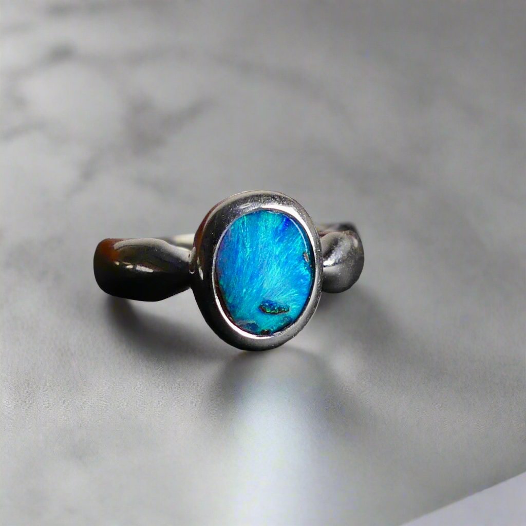 This Vibrant Sterling Silver Boulder Opal Ring showcases stunning ocean blue hues, making it a truly eye-catching accessory. Crafted with high-quality sterling silver and featuring a boulder opal, this ring is both beautiful and durable. Elevate any outfit with this striking piece of jewelry.

Origin- Ethically mined in Queensland Australia

Opal Weight- 1.9ct

Setting- Sterling Silver

Size- 6 1/2us

Crafted By Passionate Australian Artisans