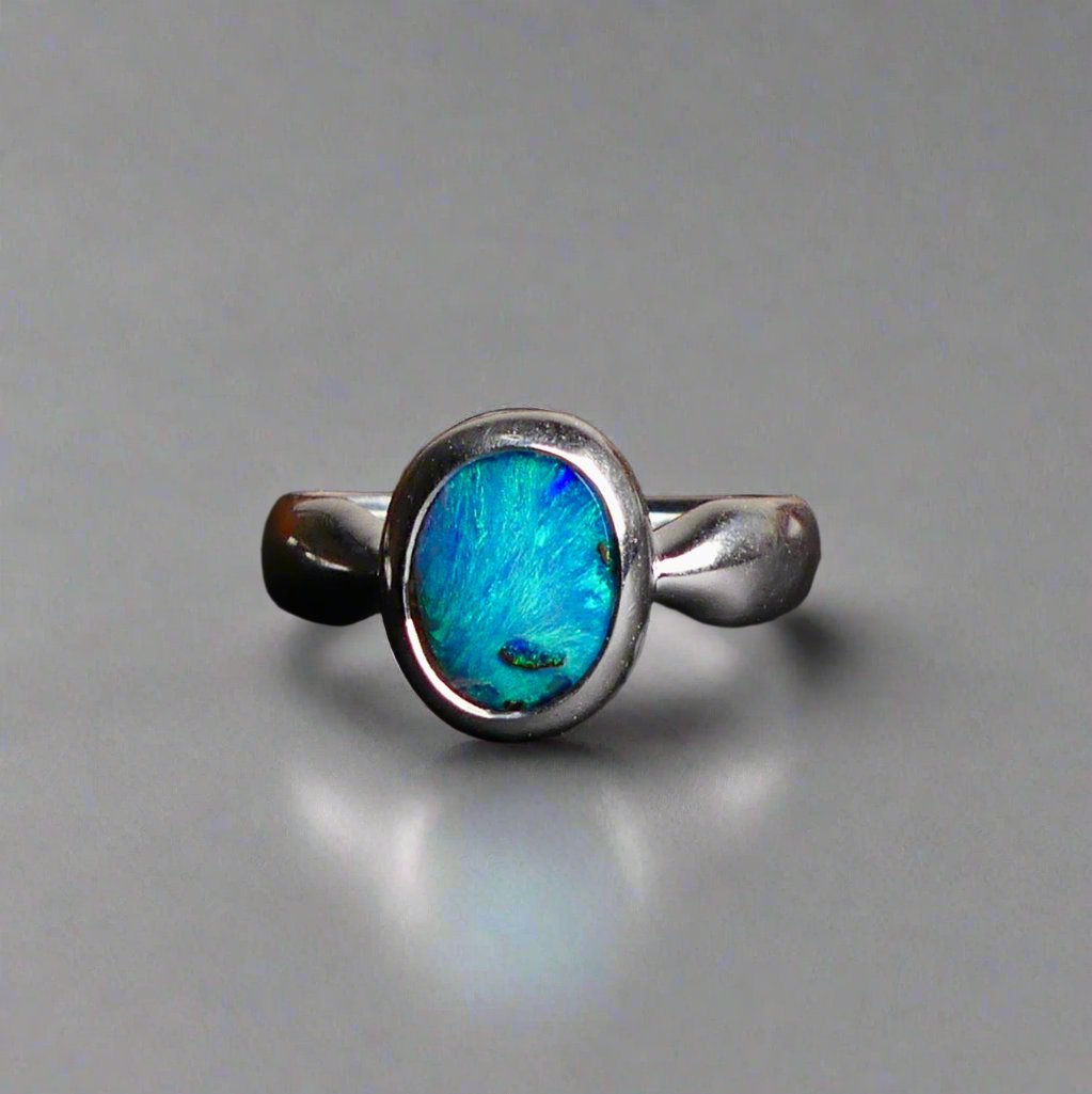 This Vibrant Sterling Silver Boulder Opal Ring showcases stunning ocean blue hues, making it a truly eye-catching accessory. Crafted with high-quality sterling silver and featuring a boulder opal, this ring is both beautiful and durable. Elevate any outfit with this striking piece of jewelry.

Origin- Ethically mined in Queensland Australia

Opal Weight- 1.9ct

Setting- Sterling Silver

Size- 6 1/2us

Crafted By Passionate Australian Artisans
