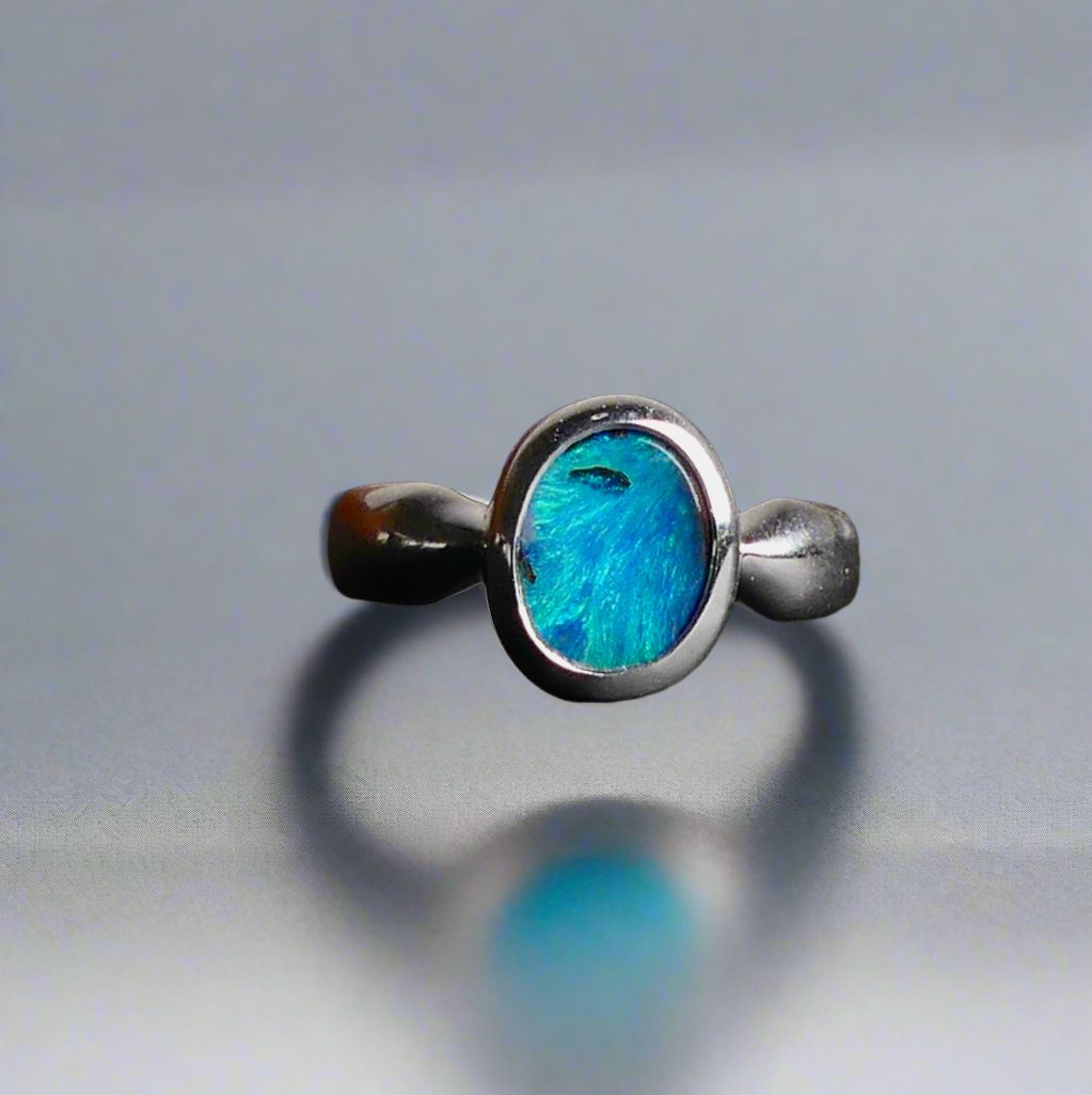 This Vibrant Sterling Silver Boulder Opal Ring showcases stunning ocean blue hues, making it a truly eye-catching accessory. Crafted with high-quality sterling silver and featuring a boulder opal, this ring is both beautiful and durable. Elevate any outfit with this striking piece of jewelry.

Origin- Ethically mined in Queensland Australia

Opal Weight- 1.9ct

Setting- Sterling Silver

Size- 6 1/2us

Crafted By Passionate Australian Artisans